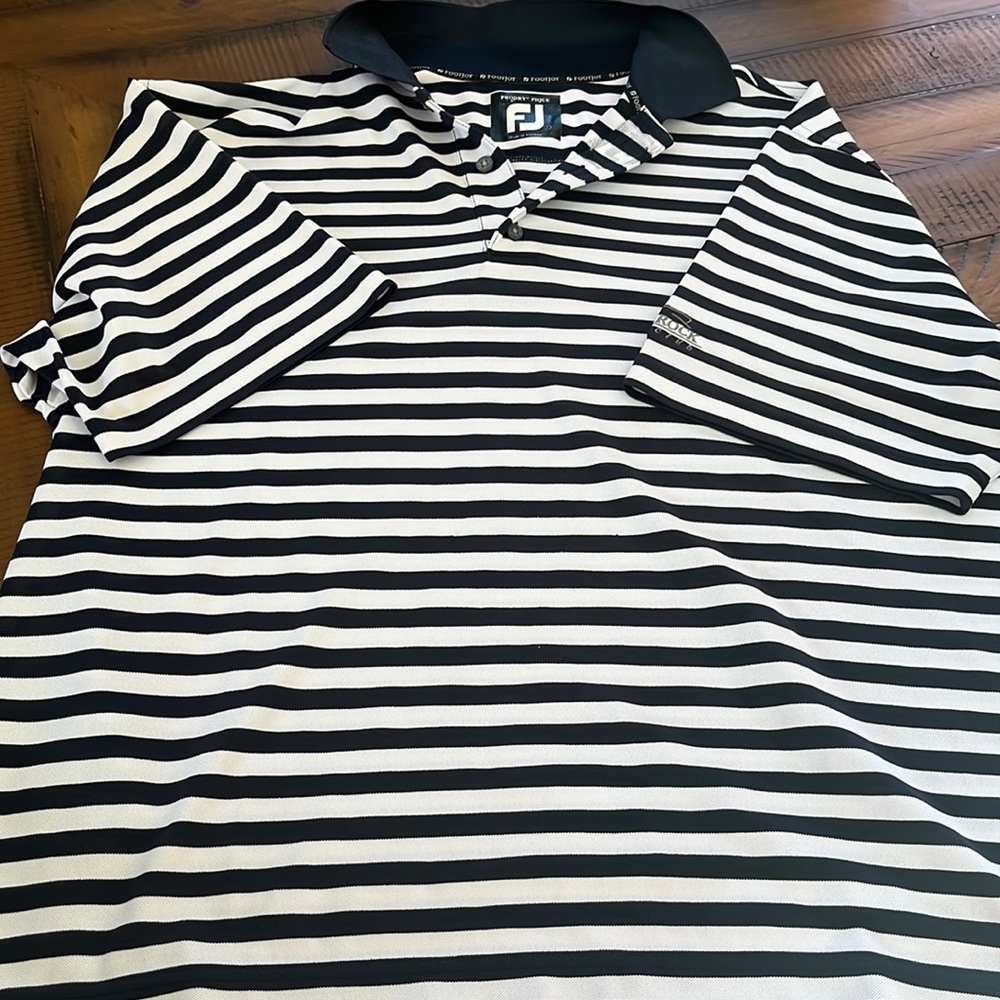 Foot joy golf polo. Navy and white striped. Club logo on arm. Never worn. Large.